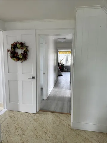 a spacious bedroom with a bed and a dresser next to a window