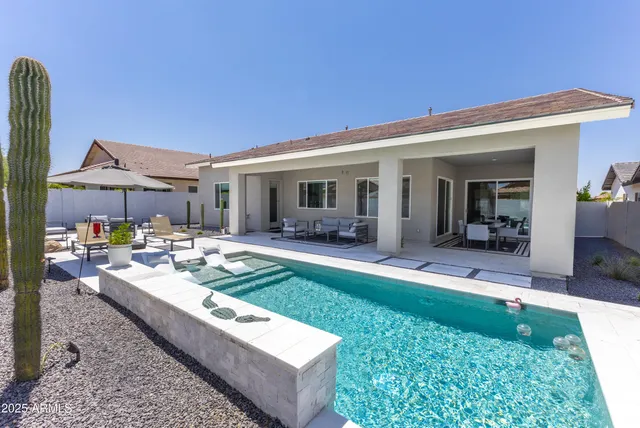 a view of a house with backyard porch and sitting area