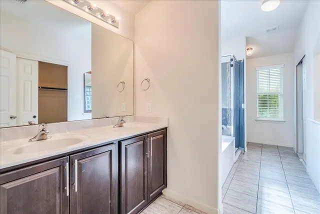 a bathroom with a sink vanity granite and a mirror