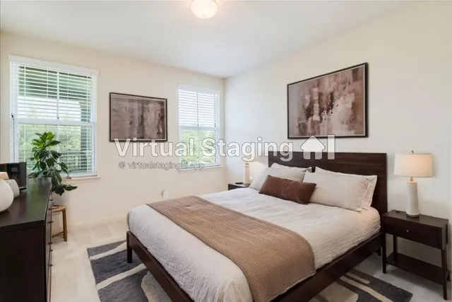 a bedroom with a large bed and a potted plant