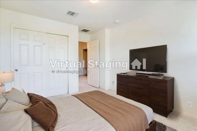 a bedroom with a bed and a flat screen tv