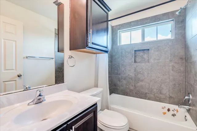 a bathroom with a sink a toilet and bathtub