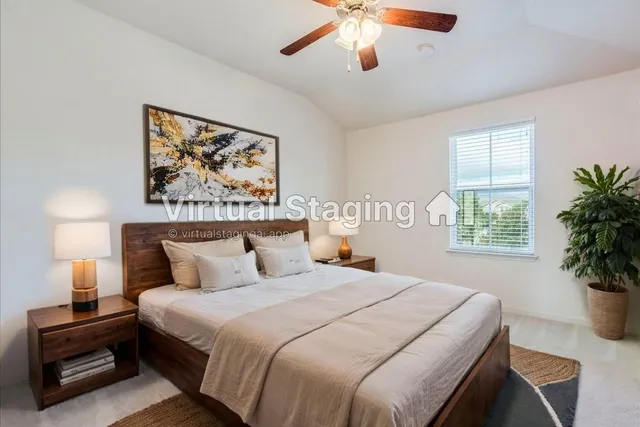 a bedroom with a large bed and a potted plant