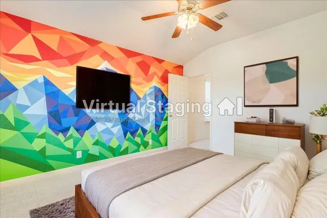 a bedroom with a bed and a flat screen tv