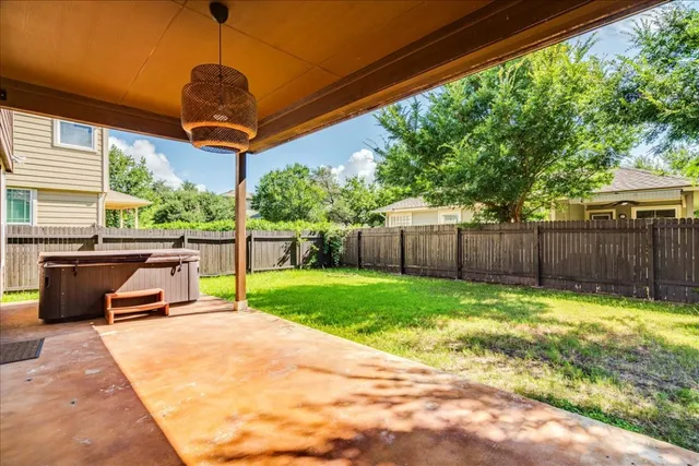 a view of a backyard with wooden fence