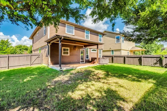 a view of a backyard with plants and large trees