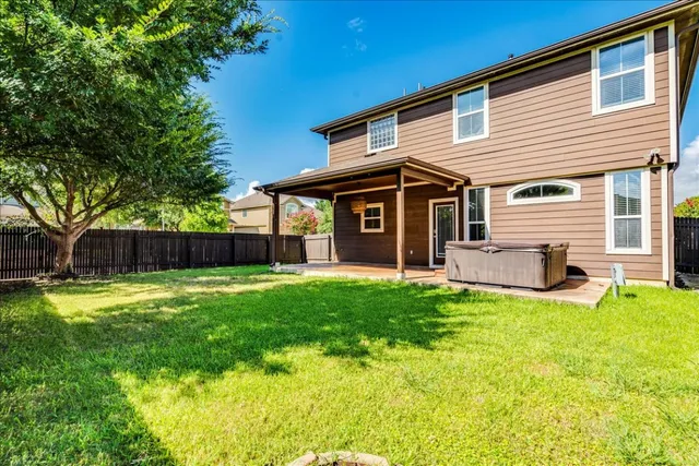 a view of a house with a backyard