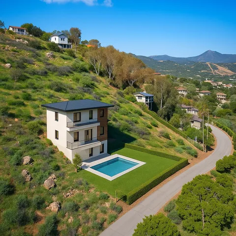 a view of a houses with a lush green hillside