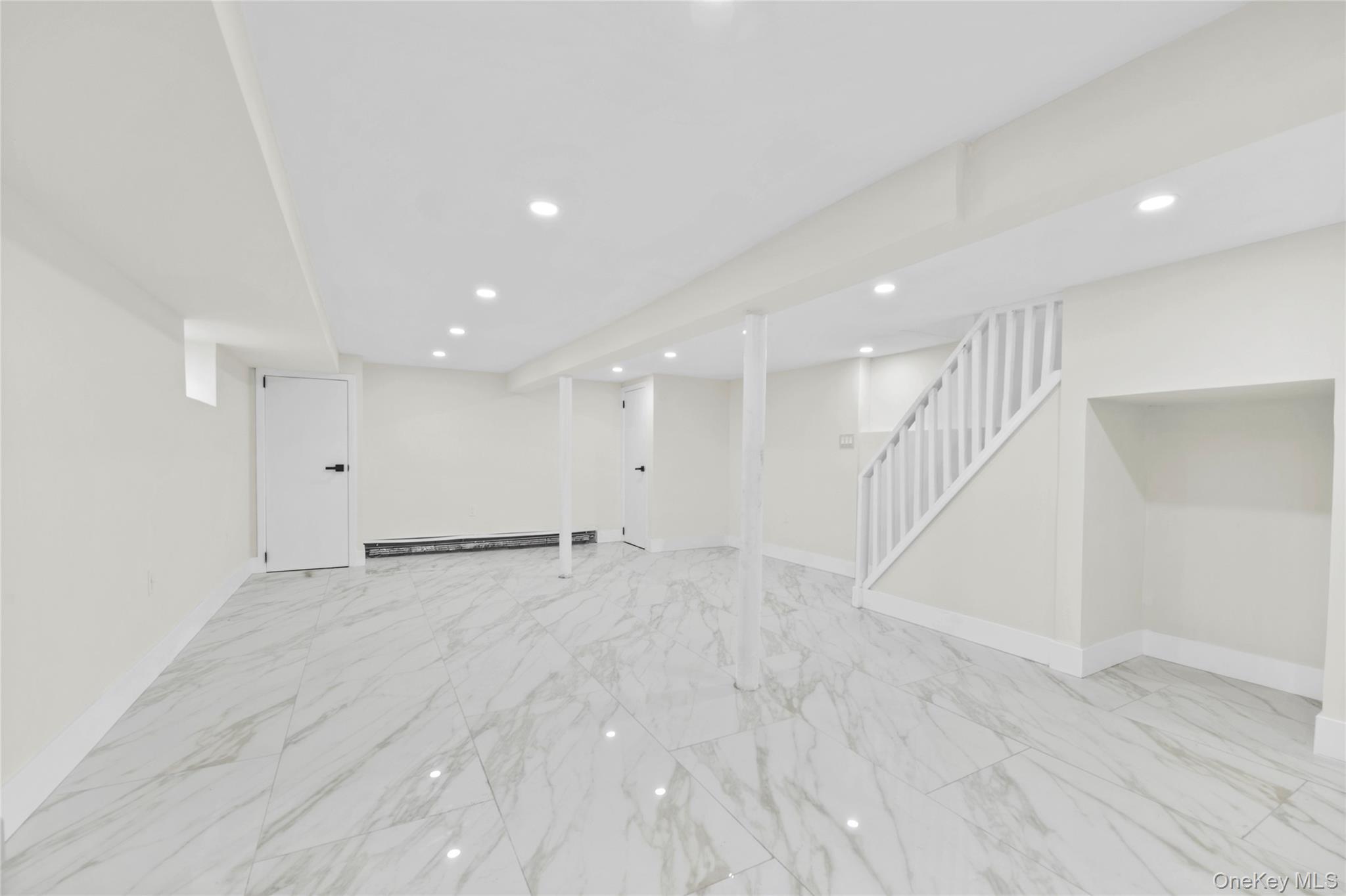 220-27 134th Road Queens, NY 11413 - Photo 16 of 22 Finished basement with recessed lighting, light marble finish floors, and stairway