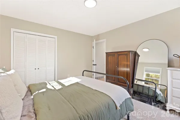 a bedroom with a bed and a mirror