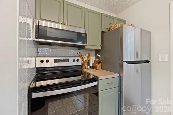 a kitchen with a refrigerator and a stove