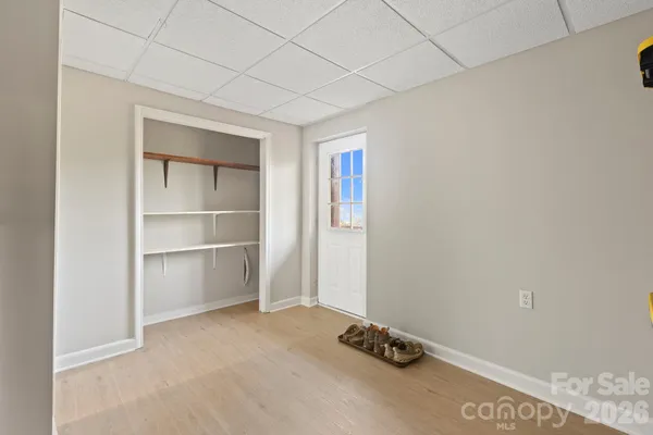a room with a closet and wooden floor