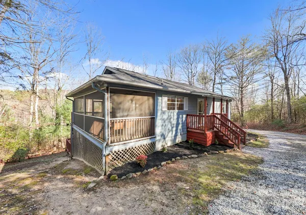 a view of a house with a yard and wooden fence