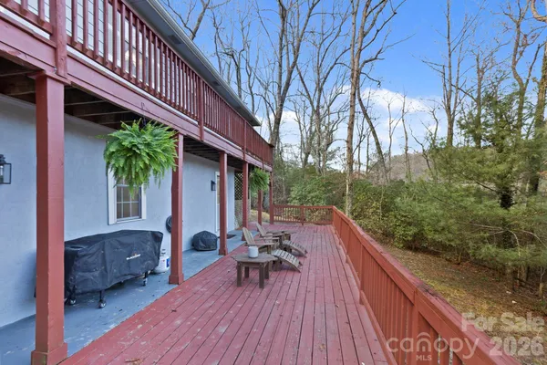a view of balcony with chairs and wooden fence