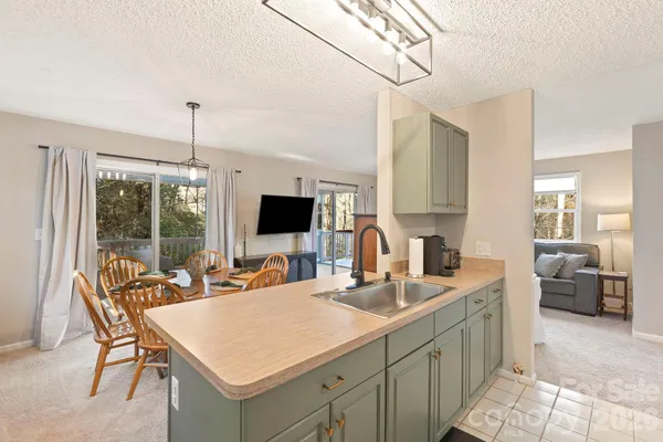 a view of a kitchen area kitchen island furniture and a flat screen tv
