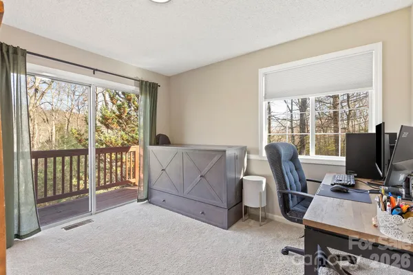 a livingroom with workspace and a window