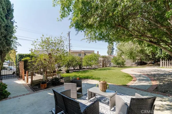 a view of yard with outdoor seating and trees