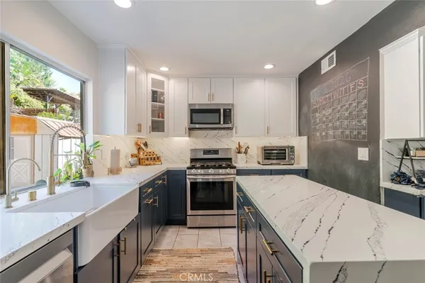 a kitchen with a sink stove and refrigerator