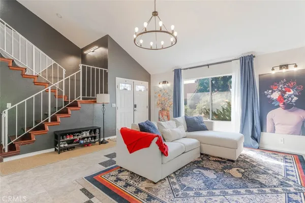 a living room with furniture and a chandelier