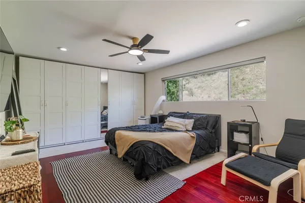 a bedroom with a bed window and a table