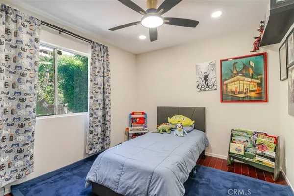 a bedroom with a bed and a window