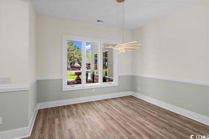 1028 Colette Court Conway, SC 29526 - Photo 11 of 39 Unfurnished dining area with wood finished floors and a chandelier