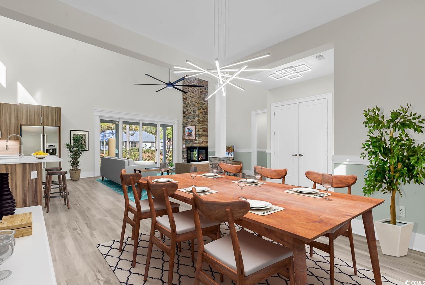 1028 Colette Court Conway, SC 29526 - Photo 15 of 39 Dining area with a high ceiling, light wood-type flooring, and a fireplace