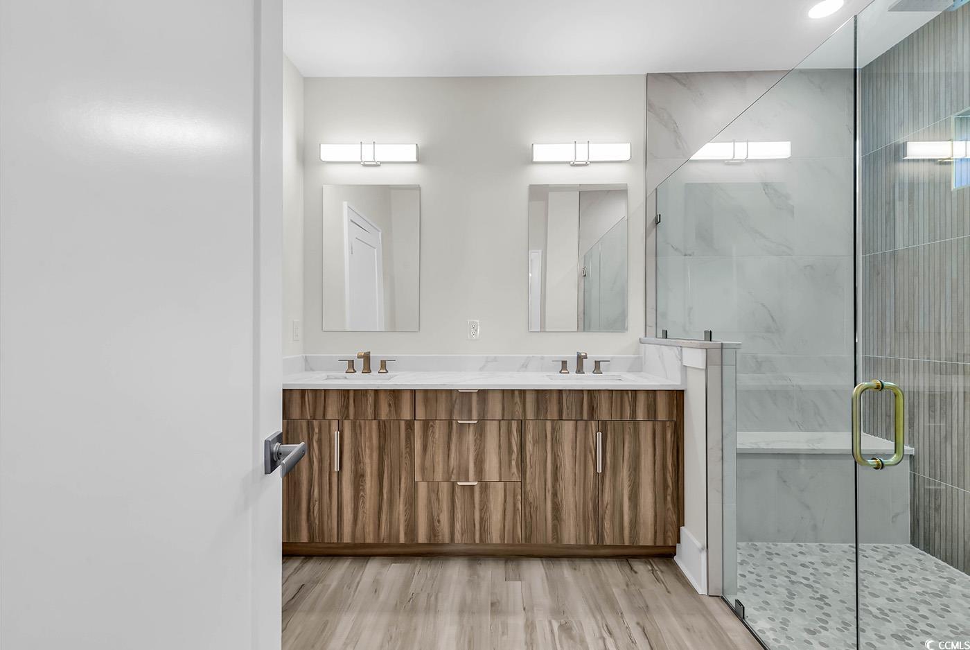 1028 Colette Court Conway, SC 29526 - Photo 21 of 39 Full bath featuring a marble finish shower, light wood-style flooring, and double vanity