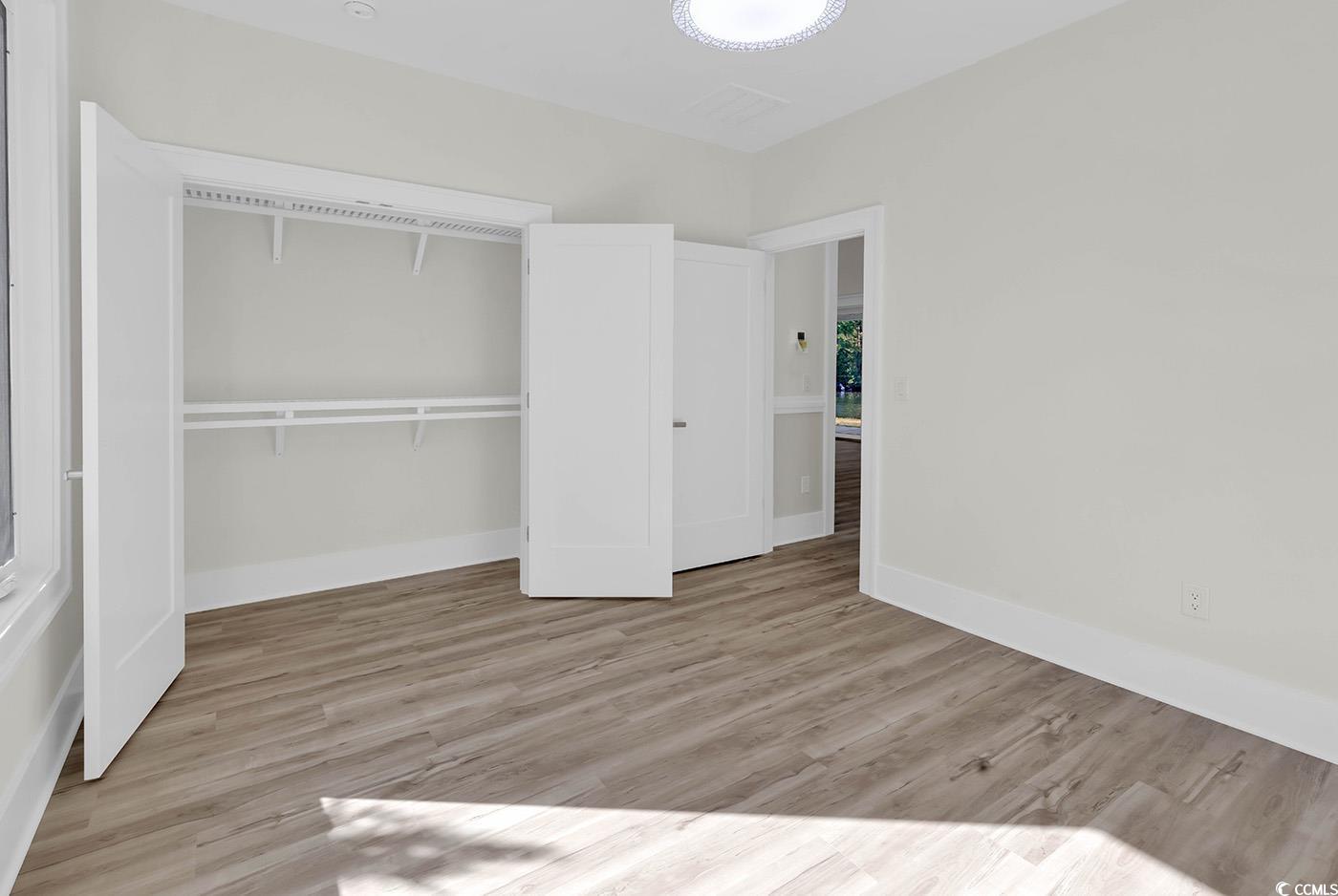1028 Colette Court Conway, SC 29526 - Photo 28 of 39 Unfurnished bedroom featuring light wood-style floors and a closet
