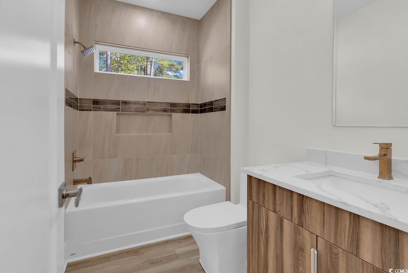 1028 Colette Court Conway, SC 29526 - Photo 29 of 39 Full bath featuring vanity, shower / bathtub combination, and light wood-style flooring