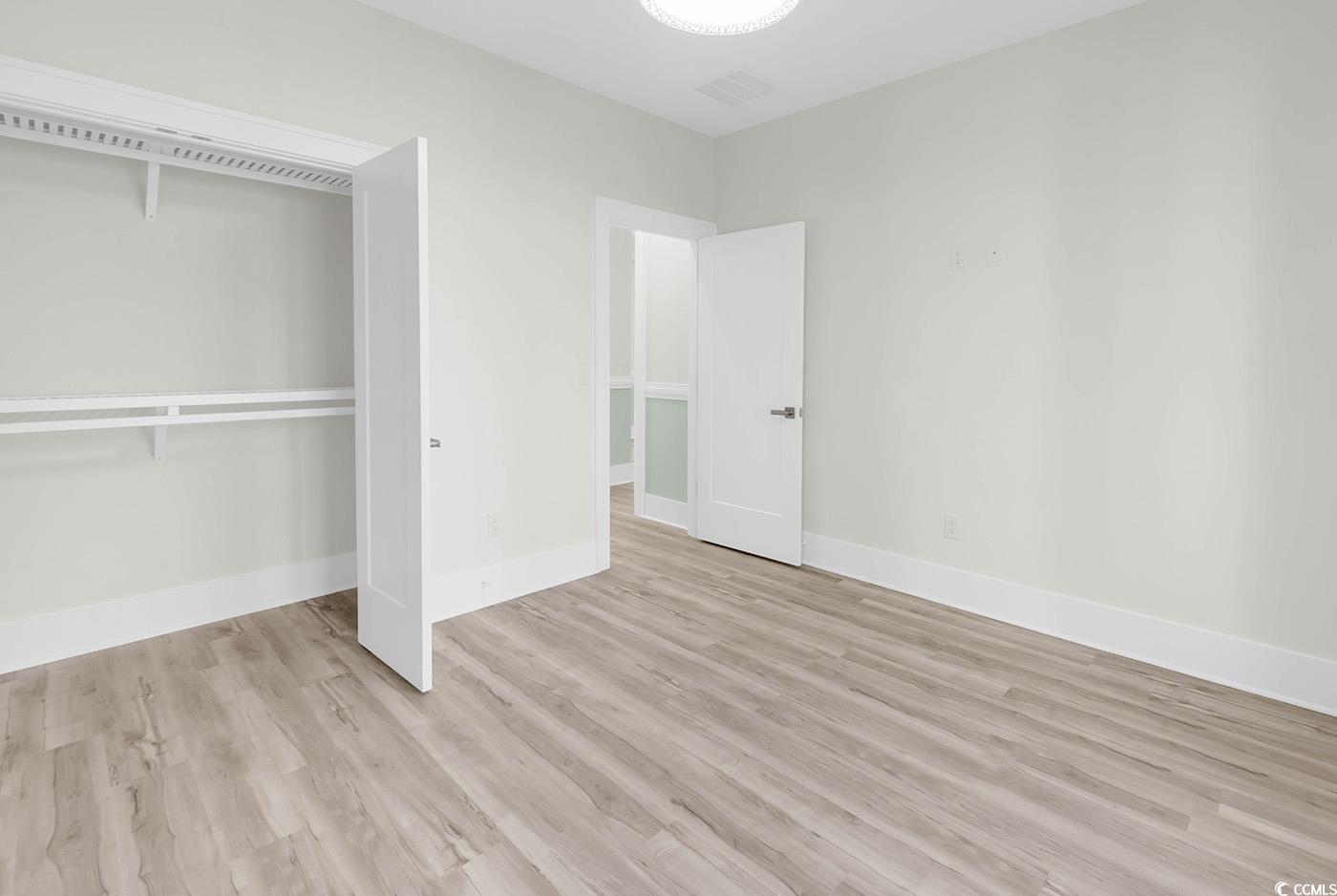 1028 Colette Court Conway, SC 29526 - Photo 31 of 39 Unfurnished bedroom featuring light wood-style flooring and a closet