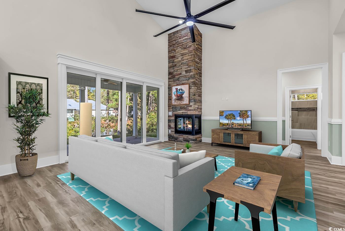 1028 Colette Court Conway, SC 29526 - Photo 7 of 39 Living area with a fireplace, wood finished floors, ceiling fan, and a towering ceiling