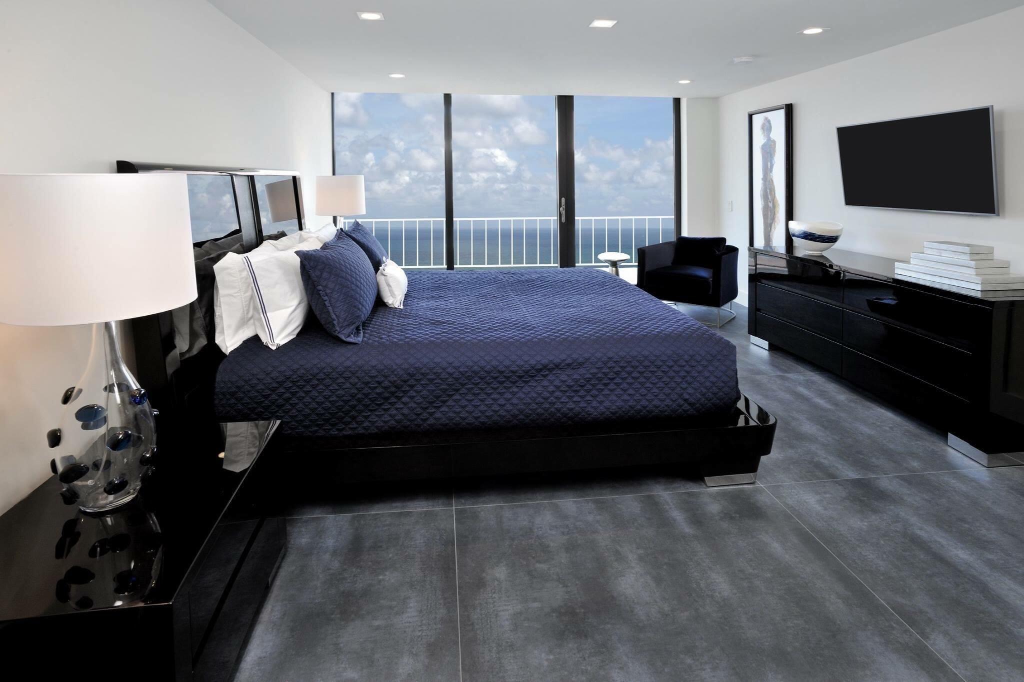 2917 South Ocean Boulevard, Unit 705 Highland Beach, FL 33487 - Photo 4 of 4 a large bed sitting in a bedroom next to a window with flat screen tv