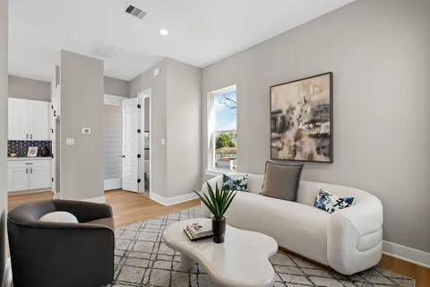 a living room with furniture and a potted plant