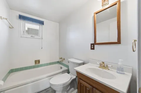 a bathroom with a sink toilet and vanity
