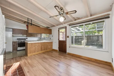 a kitchen with stainless steel appliances a stove top oven and a refrigerator