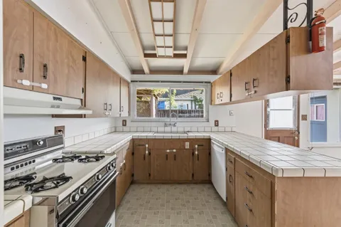 a kitchen with stainless steel appliances granite countertop a stove and a sink