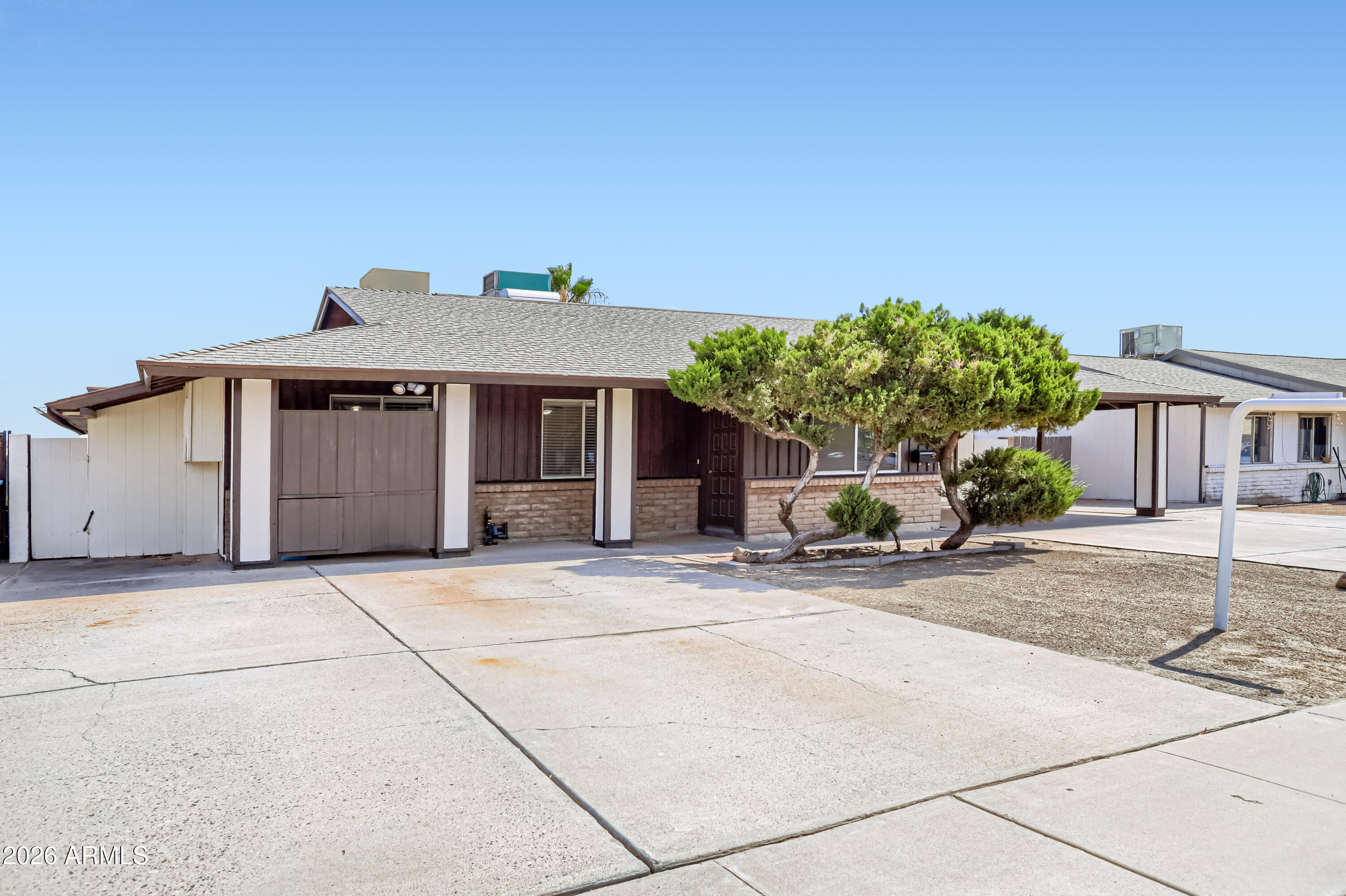 3823 West Greenway Road Phoenix, AZ 85053 - Photo 2 of 28 a front view of a house with a yard and garage