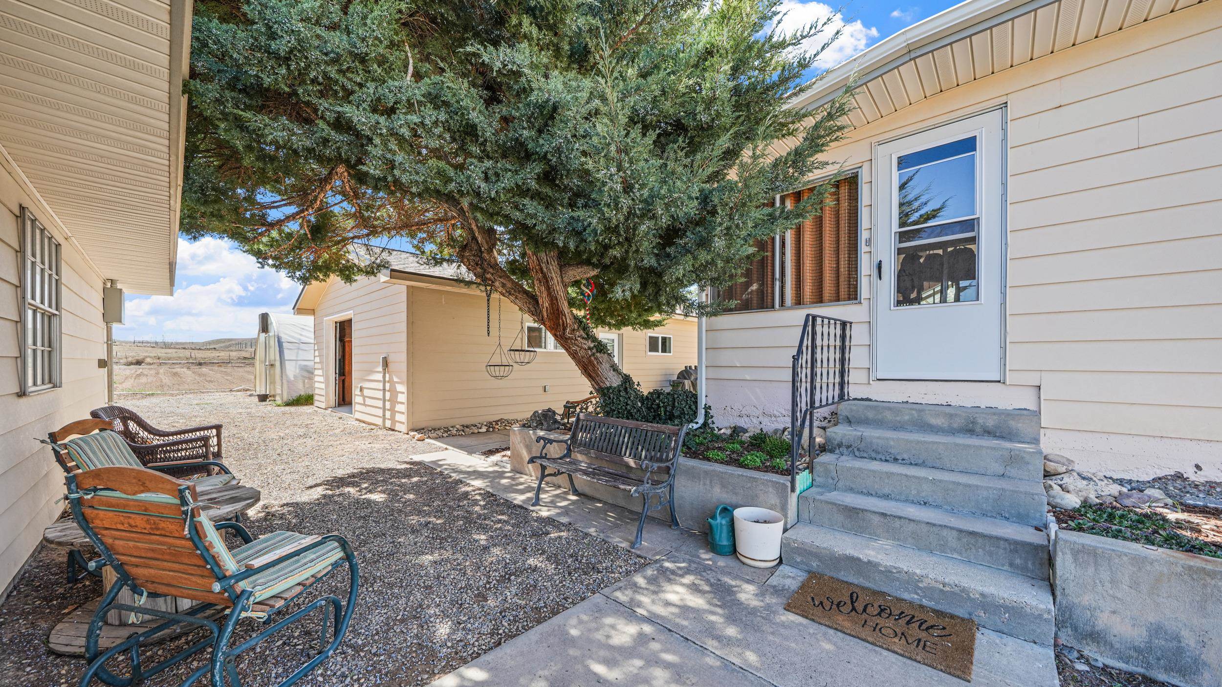 3445 C C 1/2 Road Palisade, CO 81526 - Photo 25 of 37 a view of a house with backyard and sitting area