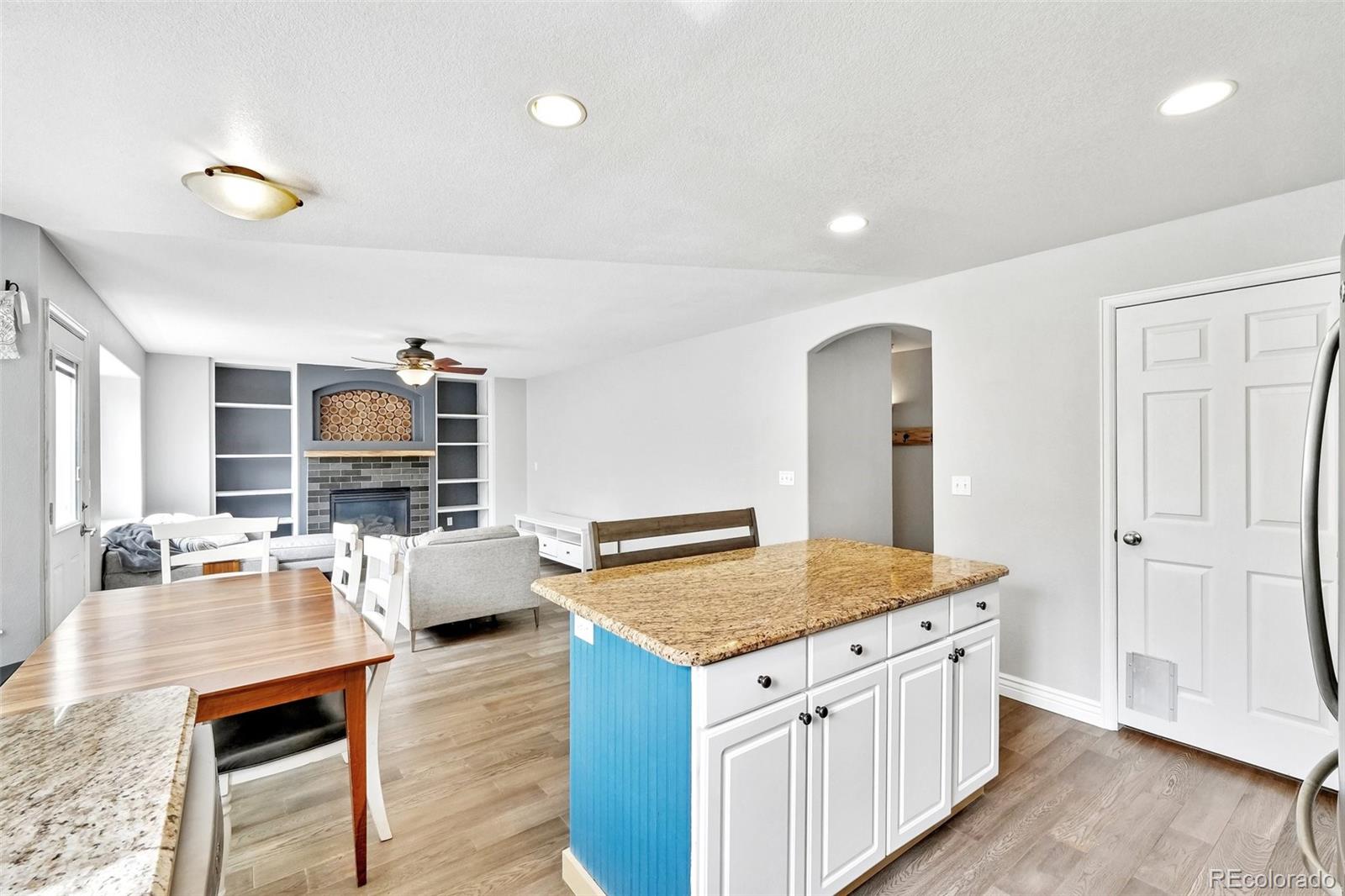 6642 Tiger Tooth Lone Tree, CO 80124 - Photo 17 of 44 a kitchen with granite countertop a sink and a stove top oven
