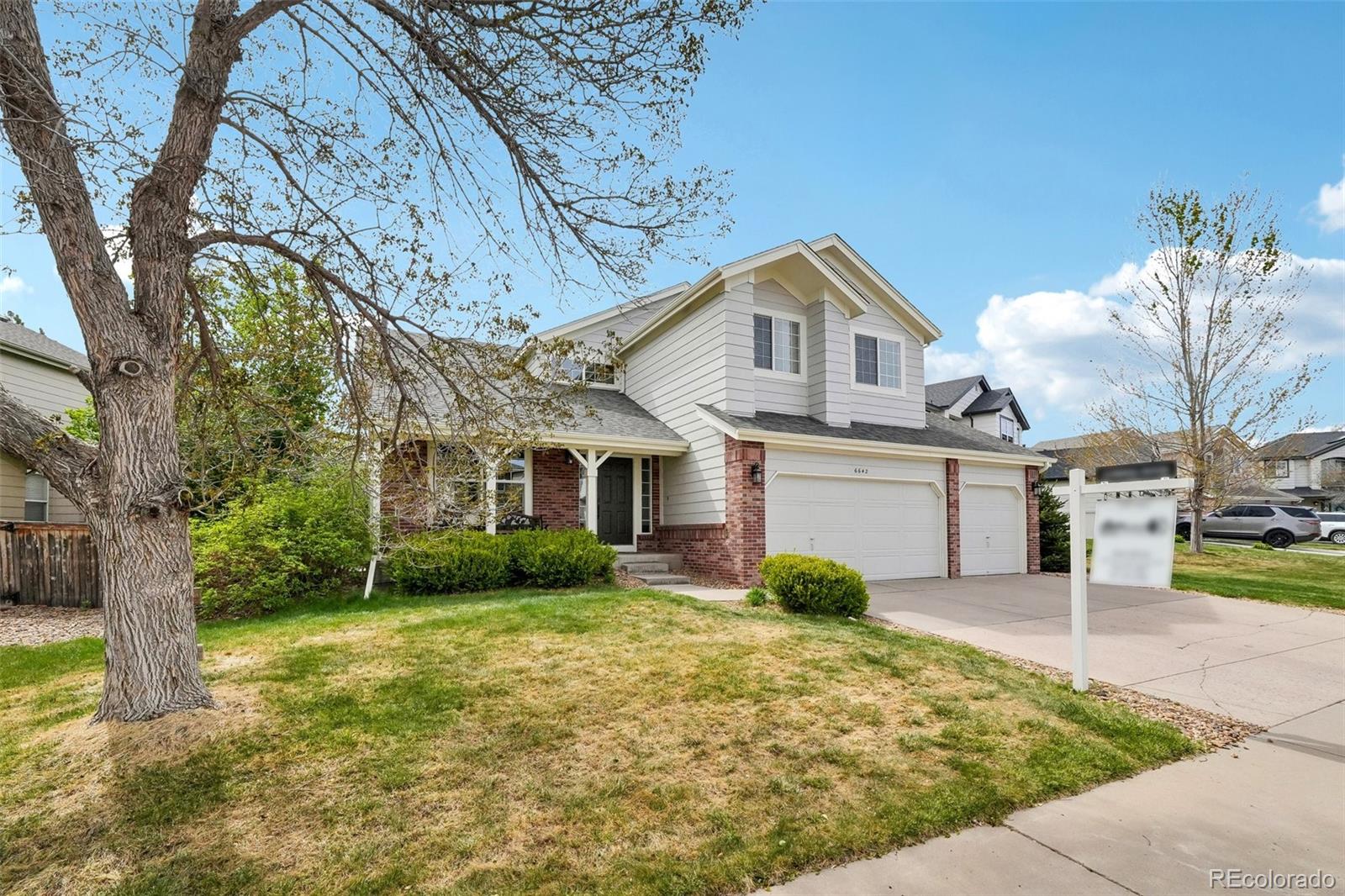 6642 Tiger Tooth Lone Tree, CO 80124 - Photo 2 of 44 a front view of a house with garden