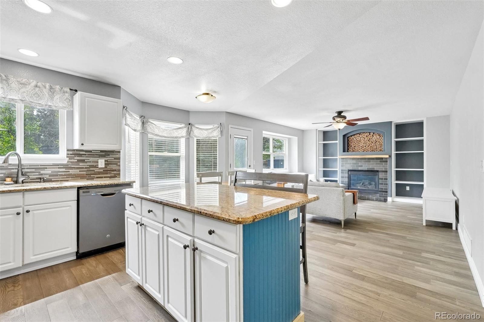 6642 Tiger Tooth Lone Tree, CO 80124 - Photo 21 of 44 a kitchen with cabinets and wooden floor