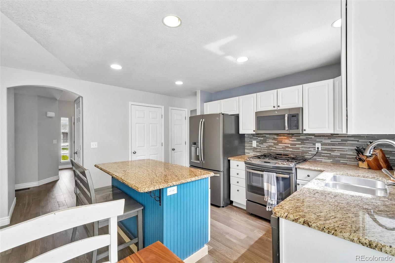 6642 Tiger Tooth Lone Tree, CO 80124 - Photo 22 of 44 a kitchen with stainless steel appliances granite countertop a sink stove and refrigerator