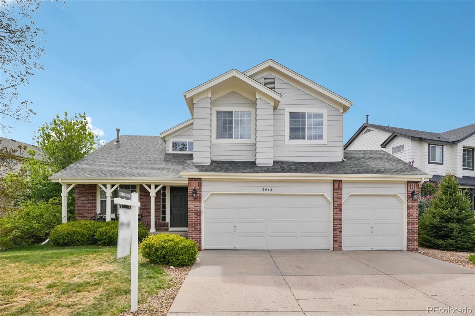 6642 Tiger Tooth Lone Tree, CO 80124 - Photo 3 of 44 a view of house with garden and tall tress