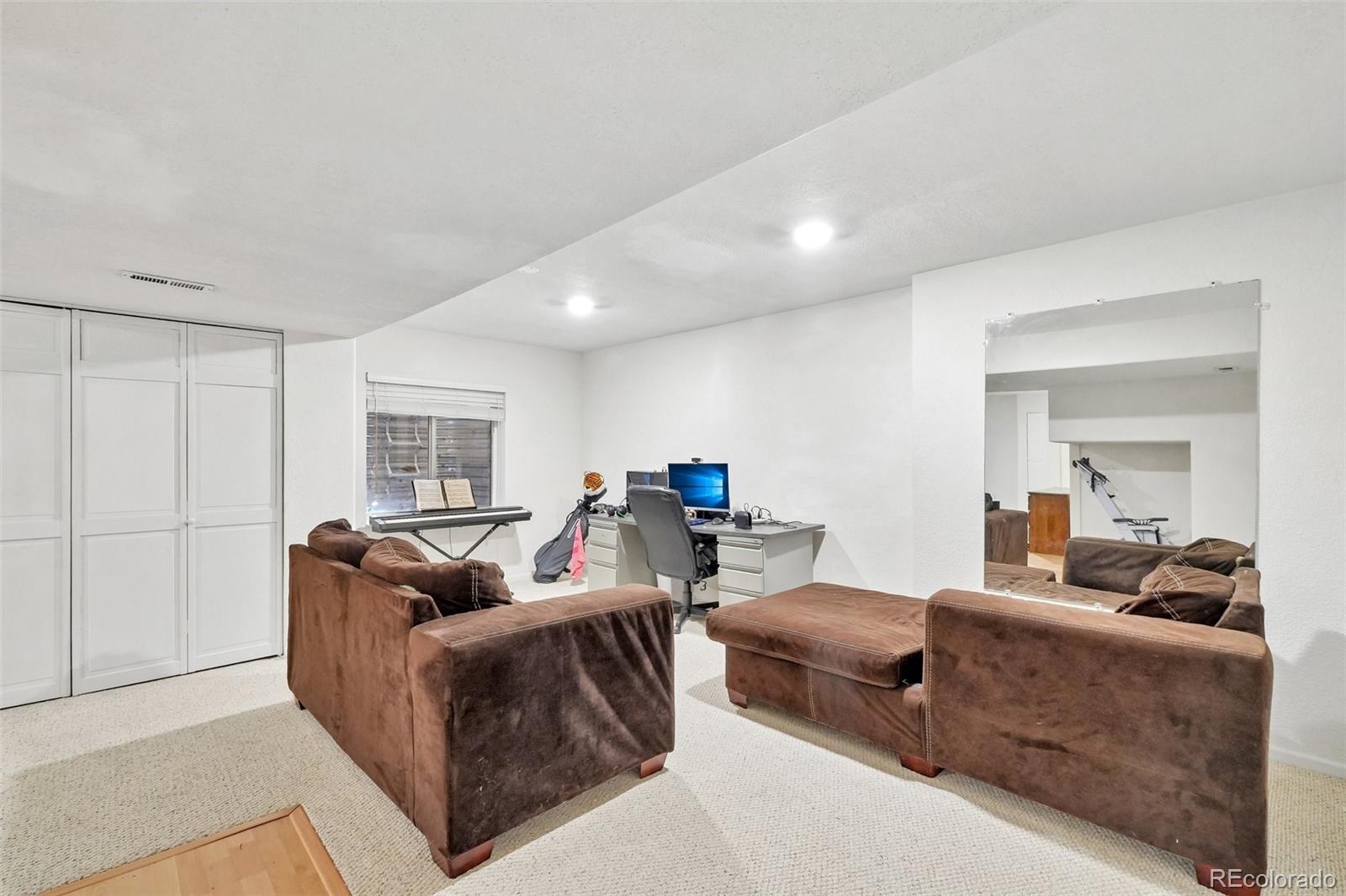 6642 Tiger Tooth Lone Tree, CO 80124 - Photo 33 of 44 a living room with furniture and a window