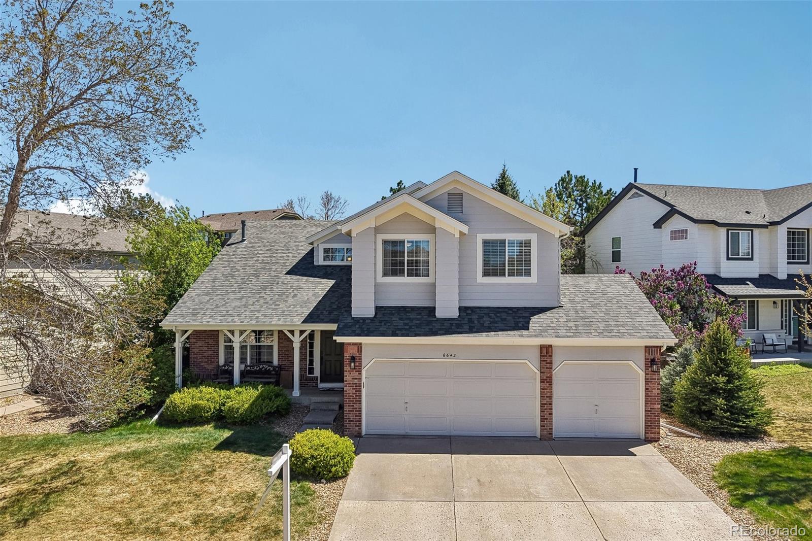 6642 Tiger Tooth Lone Tree, CO 80124 - Photo 38 of 44 a front view of a house with garden