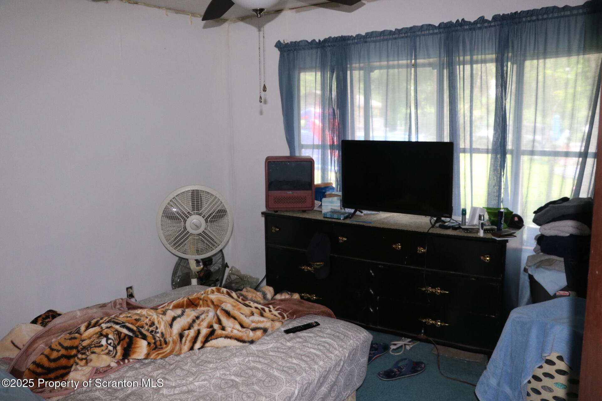 74 Matthews Road Moscow, PA 18444 - Photo 32 of 33 a bedroom with a bed and flat screen tv