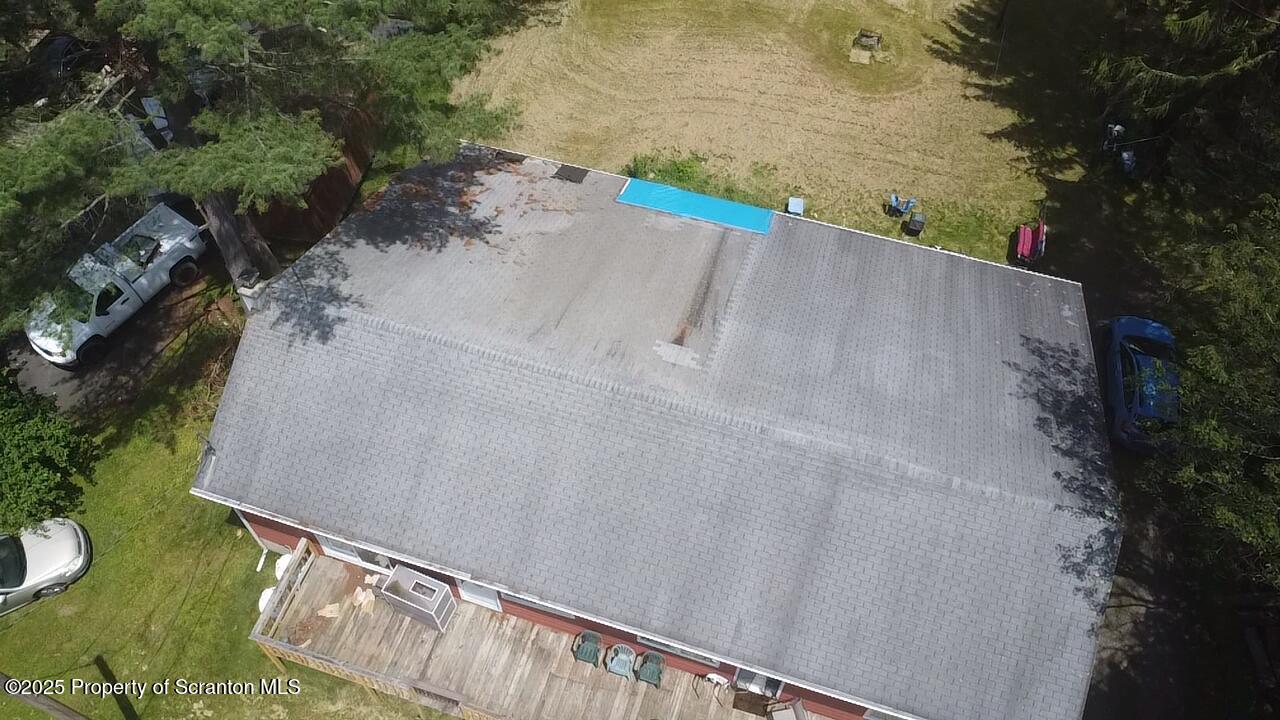74 Matthews Road Moscow, PA 18444 - Photo 7 of 33 an aerial view of a house with a yard and lake view