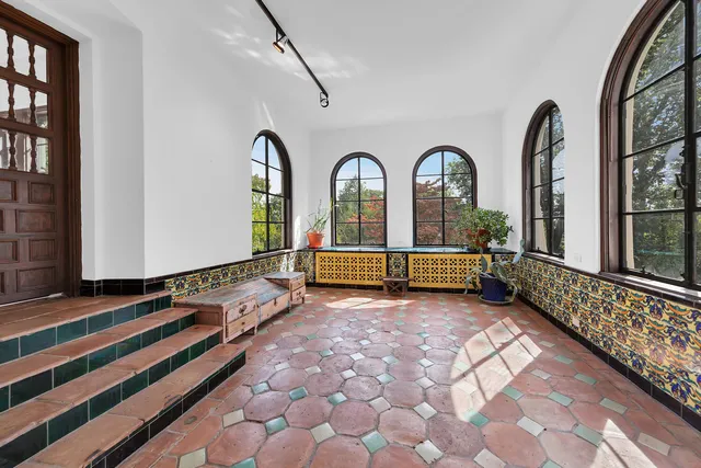 a view of an empty room with a fireplace and a window