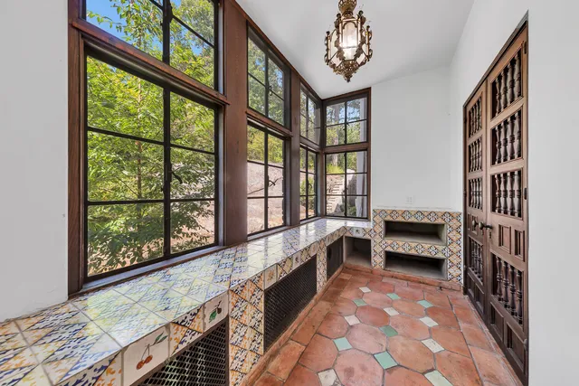 a view of a patio with table and chairs with wooden floor and fence